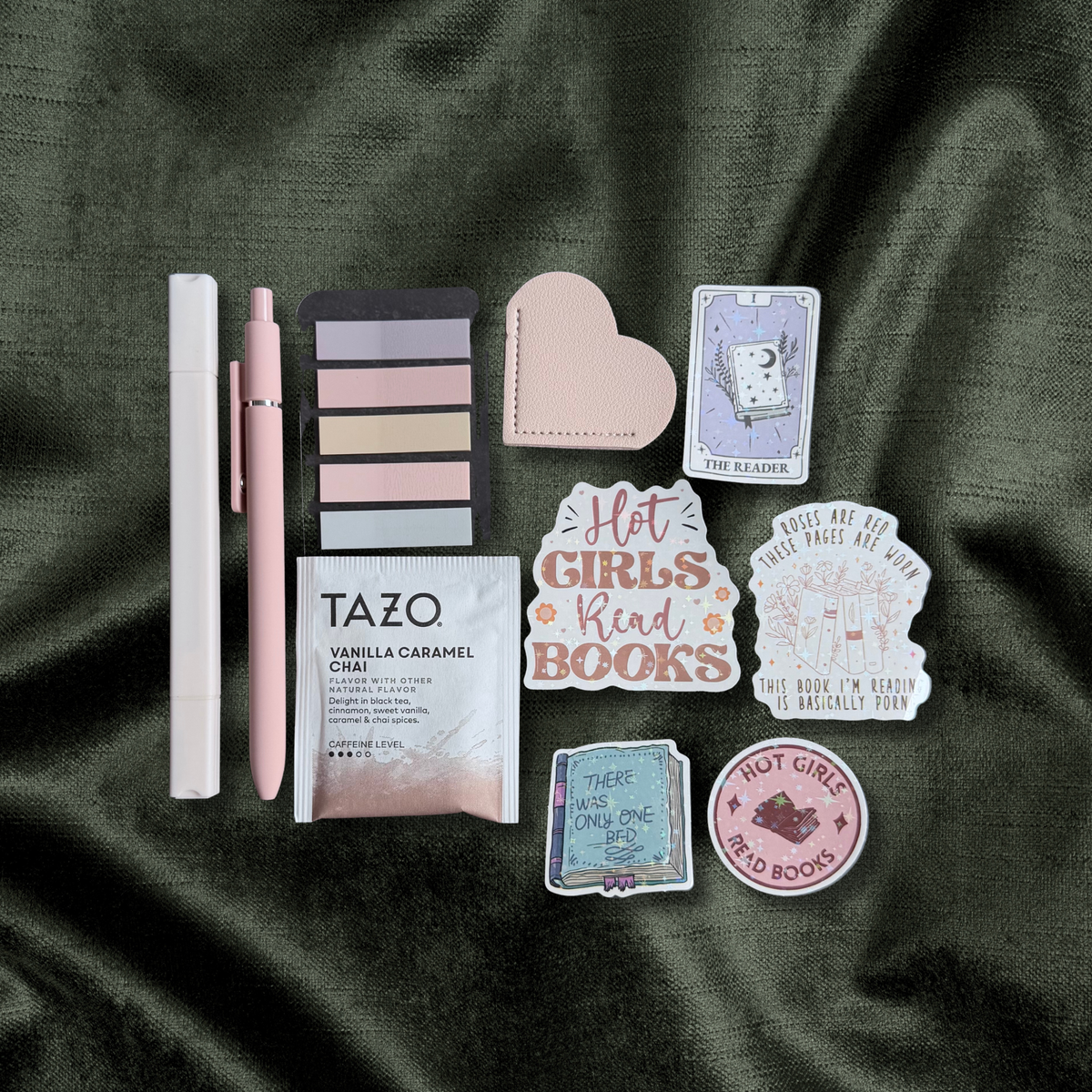 Wrapped romance Blind Date with a Book with annotation tabs, tea, stickers, and bookmarks on dark satin
