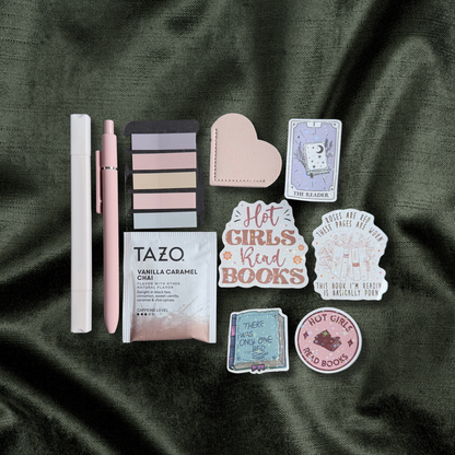 Wrapped romance Blind Date with a Book with annotation tabs, tea, stickers, and bookmarks on dark satin