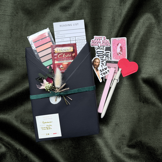 Blind Date with a Book wrapped in black paper with dried flowers and a clue tag
